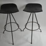 sturdy vintage metal pair of black stools against white background