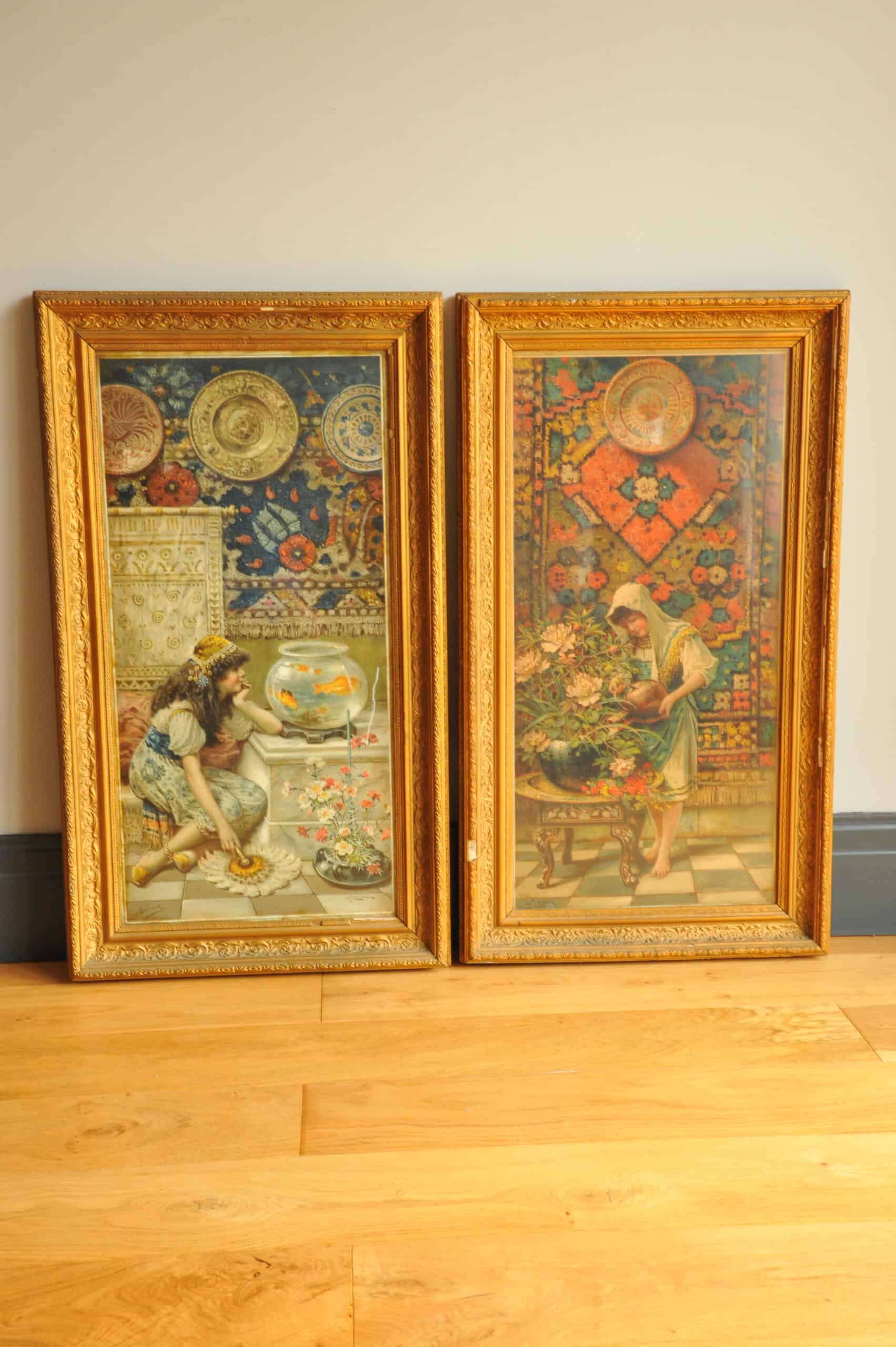 antique pair of prints of a woman gazing at fish bowl