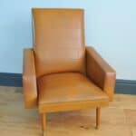 brown faux leather vintage armchair with wooden legs