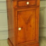 a pair of antique french walnut bedside cabinets