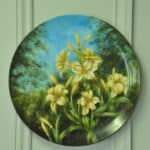 a beautiful vintage hand painted plate with lillies