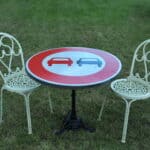 a vintage french cast iron road sign bistro café table