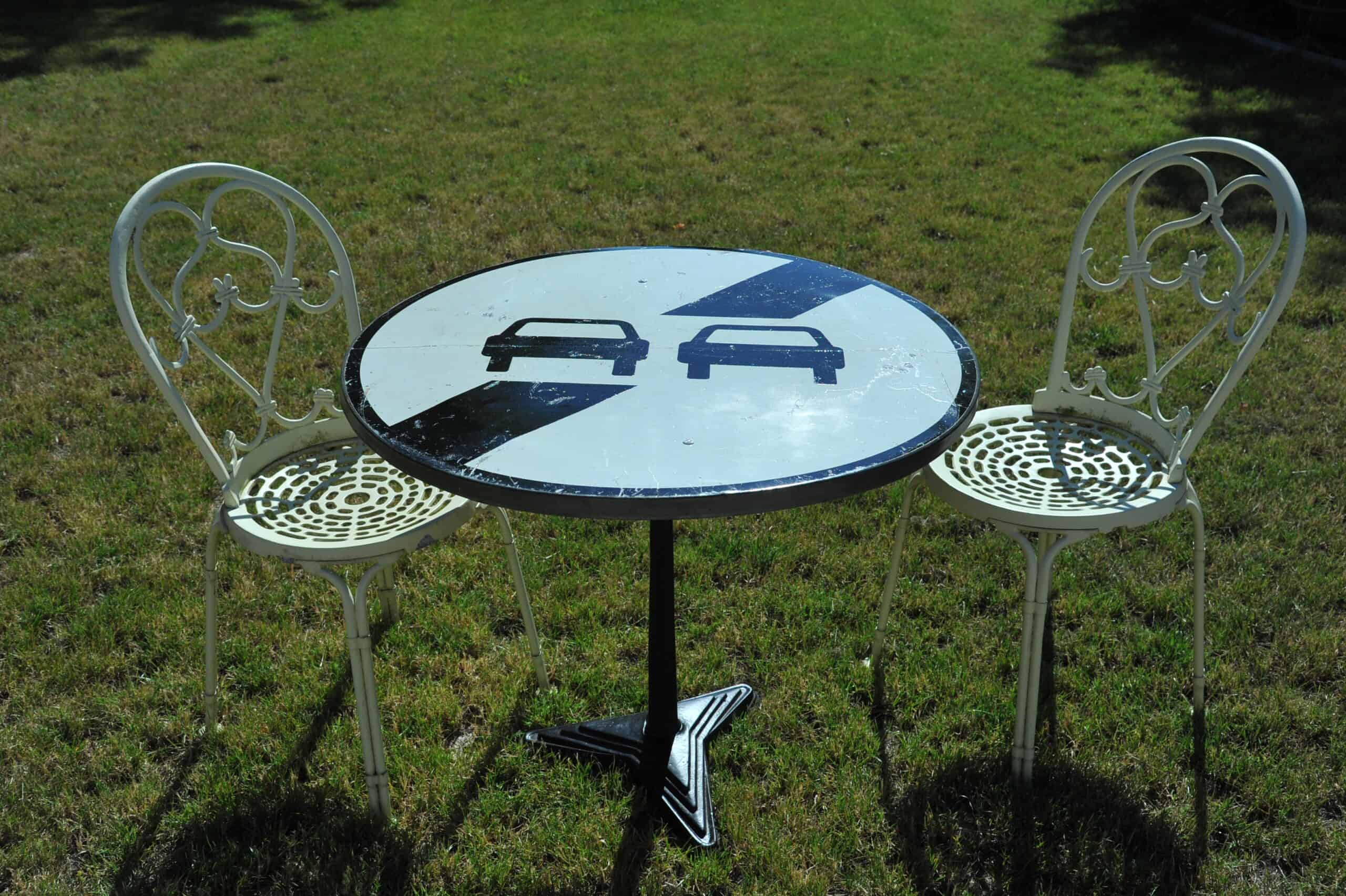 a vintage french cast iron road sign bistro café table