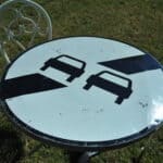 a vintage french cast iron road sign bistro café table