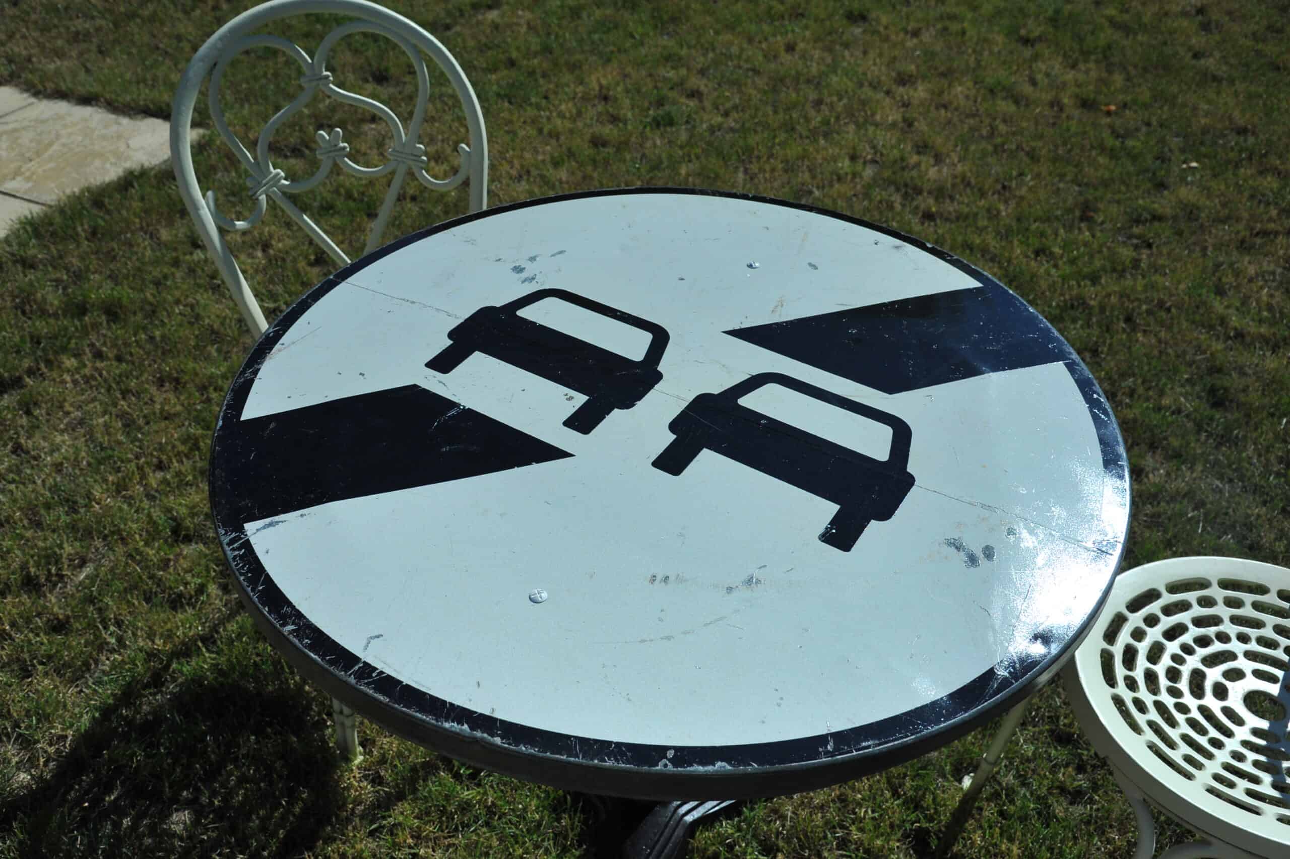 a vintage french cast iron road sign bistro café table