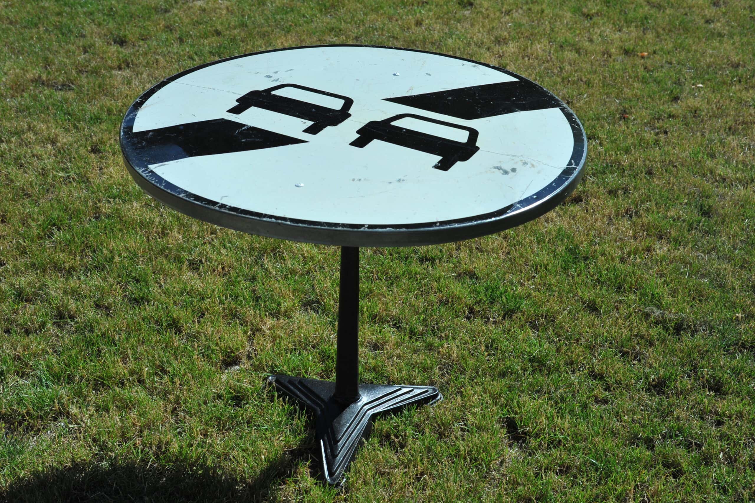 a vintage french cast iron road sign bistro café table