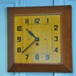 a vintage french art deco styled wooden wind up wall clock