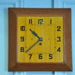 a vintage french art deco styled wooden wind up wall clock