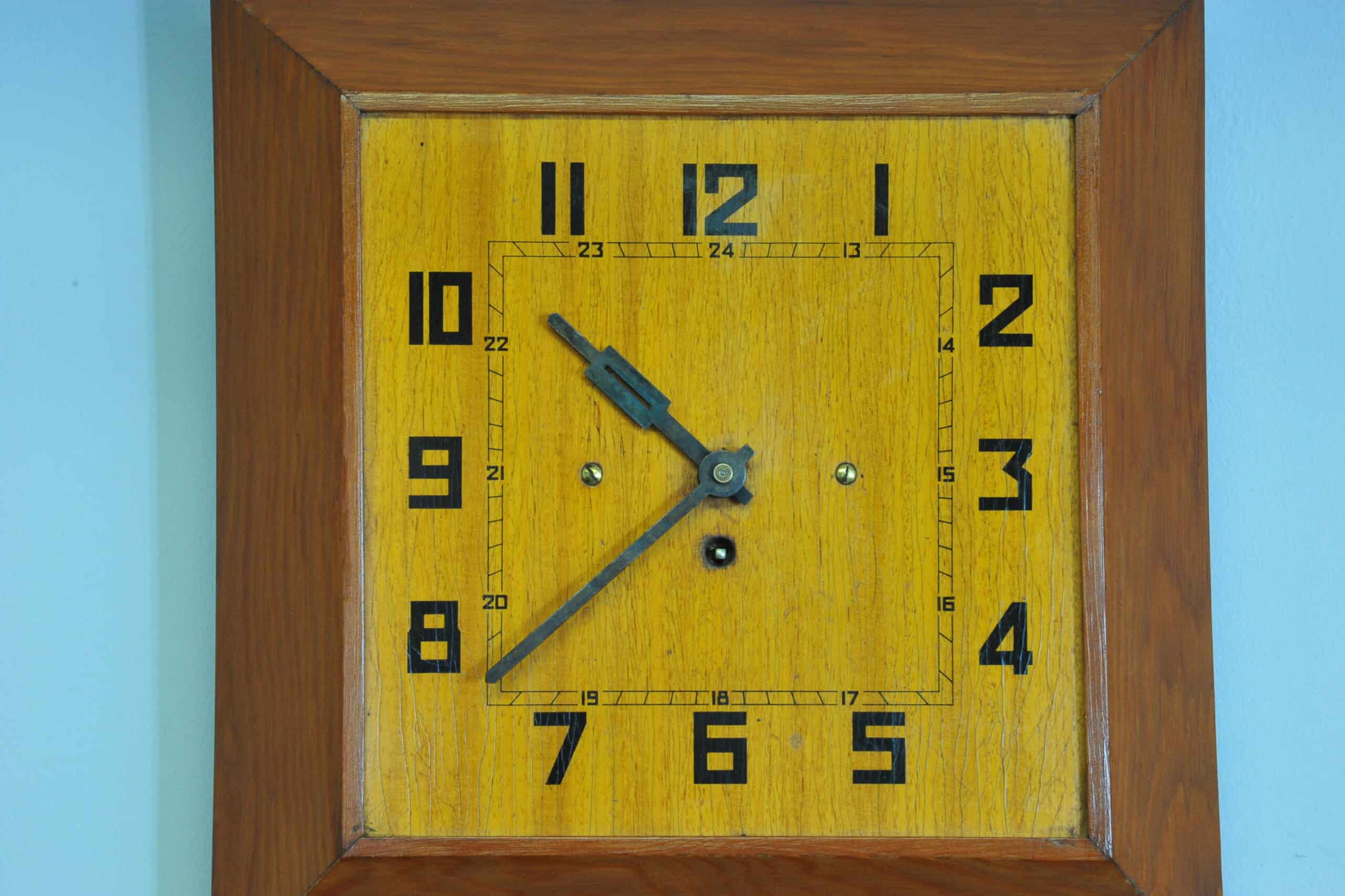 a vintage french art deco styled wooden wind up wall clock