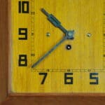 a vintage french art deco styled wooden wind up wall clock