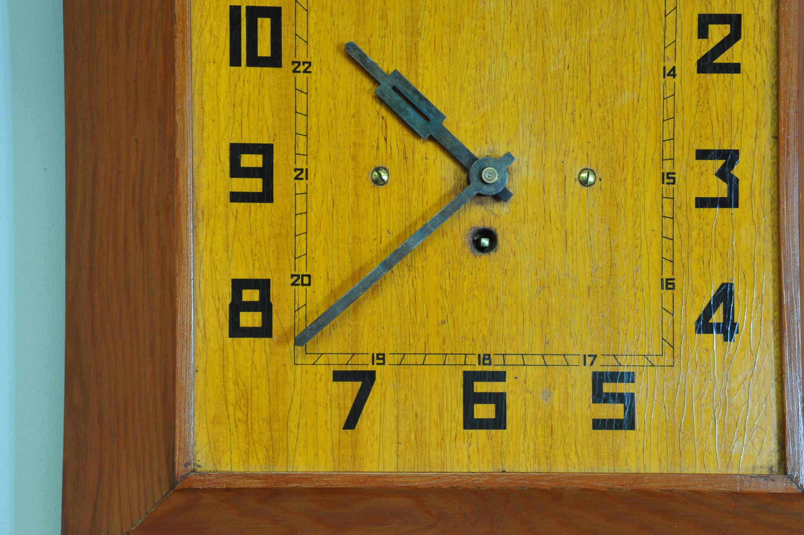 a vintage french art deco styled wooden wind up wall clock