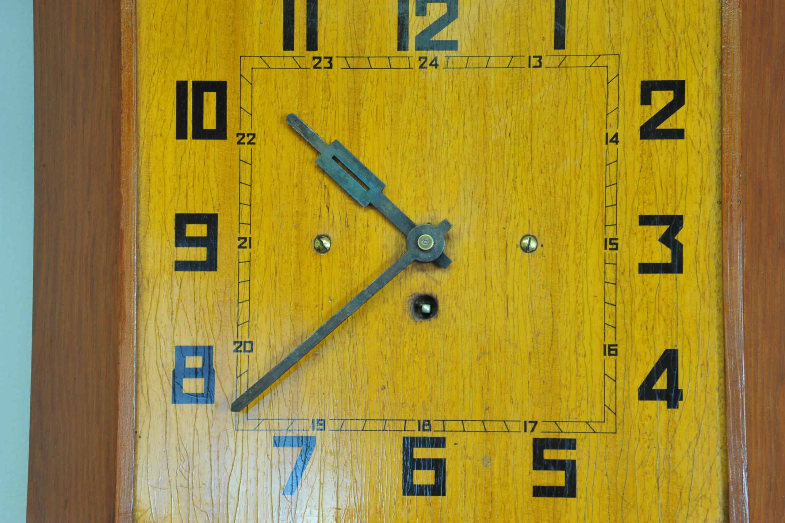 a vintage french art deco styled wooden wind up wall clock