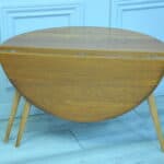 a vintage ercol round single drop leaf occasional table