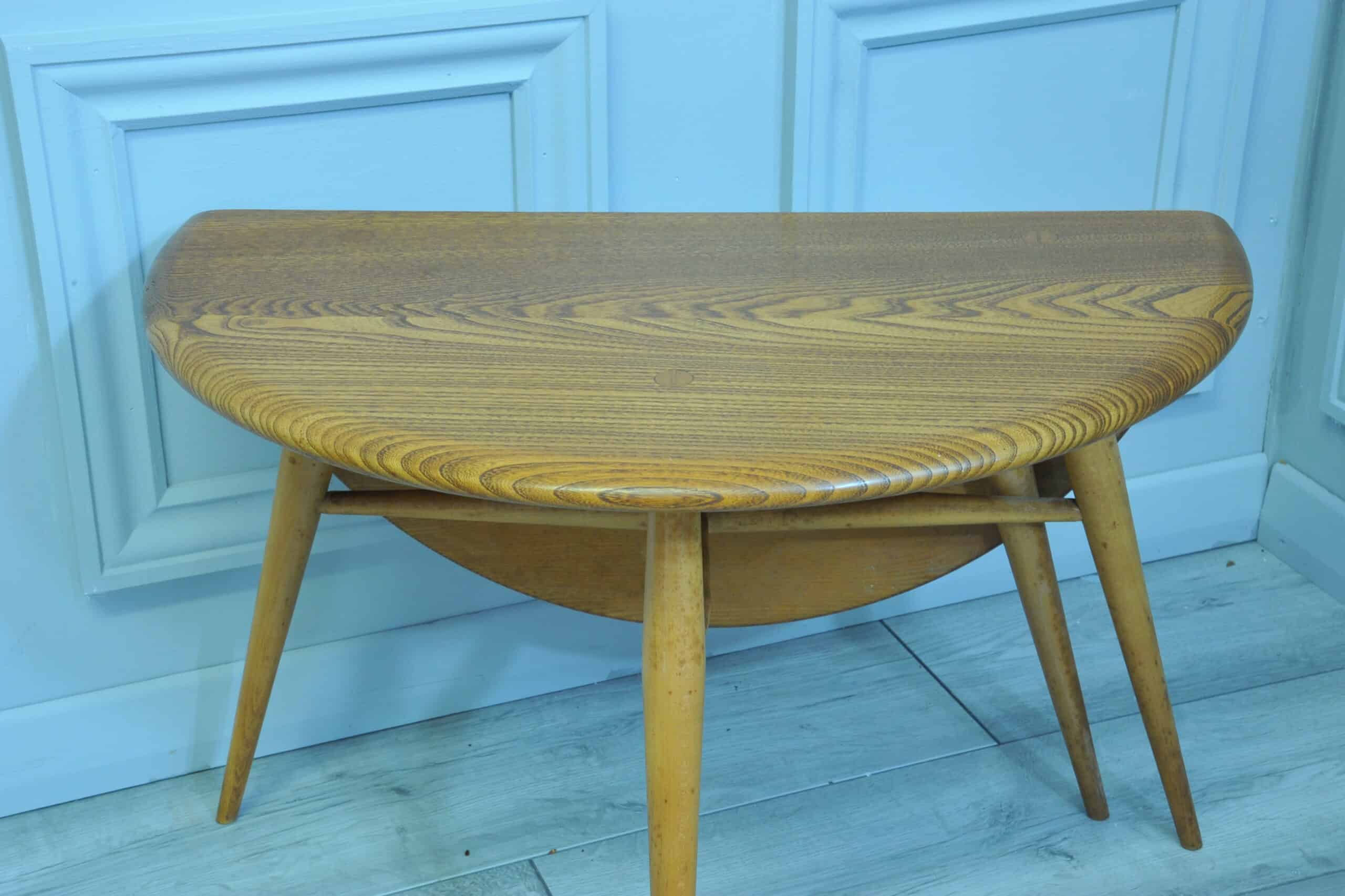 a vintage ercol round single drop leaf occasional table