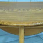 a vintage ercol round single drop leaf occasional table