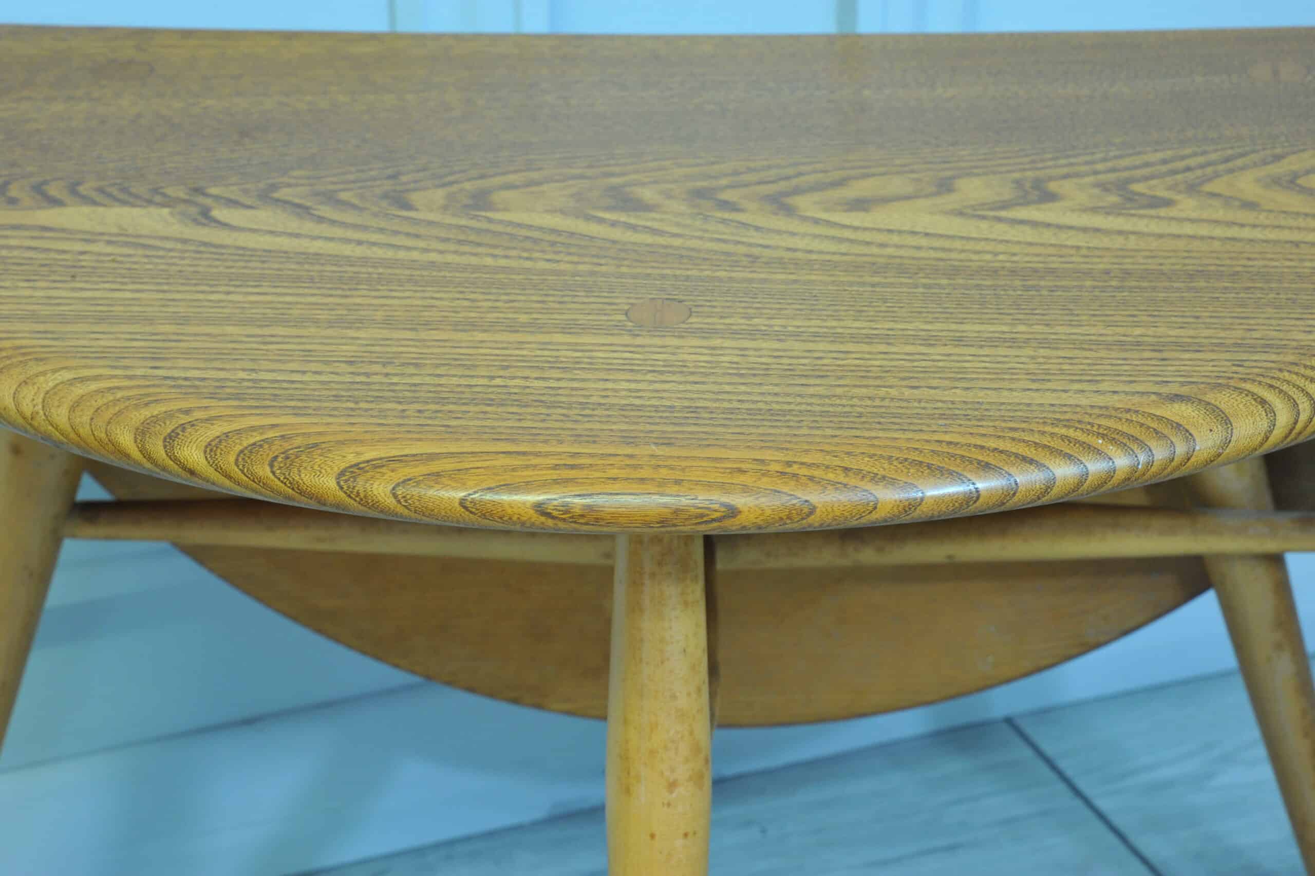 a vintage ercol round single drop leaf occasional table