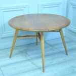 a vintage ercol round single drop leaf occasional table