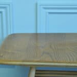 a vintage ercol long coffee table with under shelf