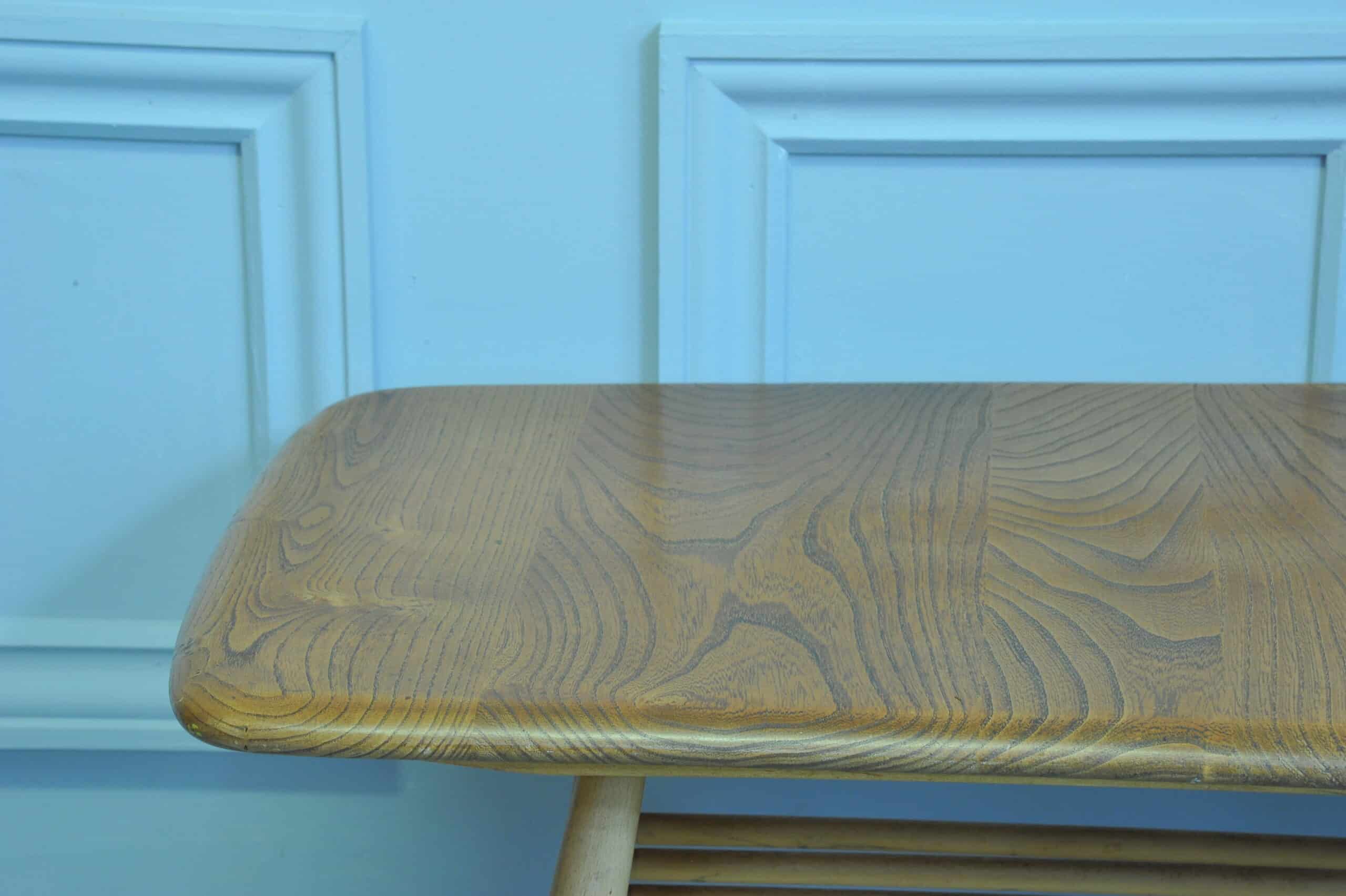 a vintage ercol long coffee table with under shelf