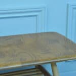 a vintage ercol long coffee table with under shelf