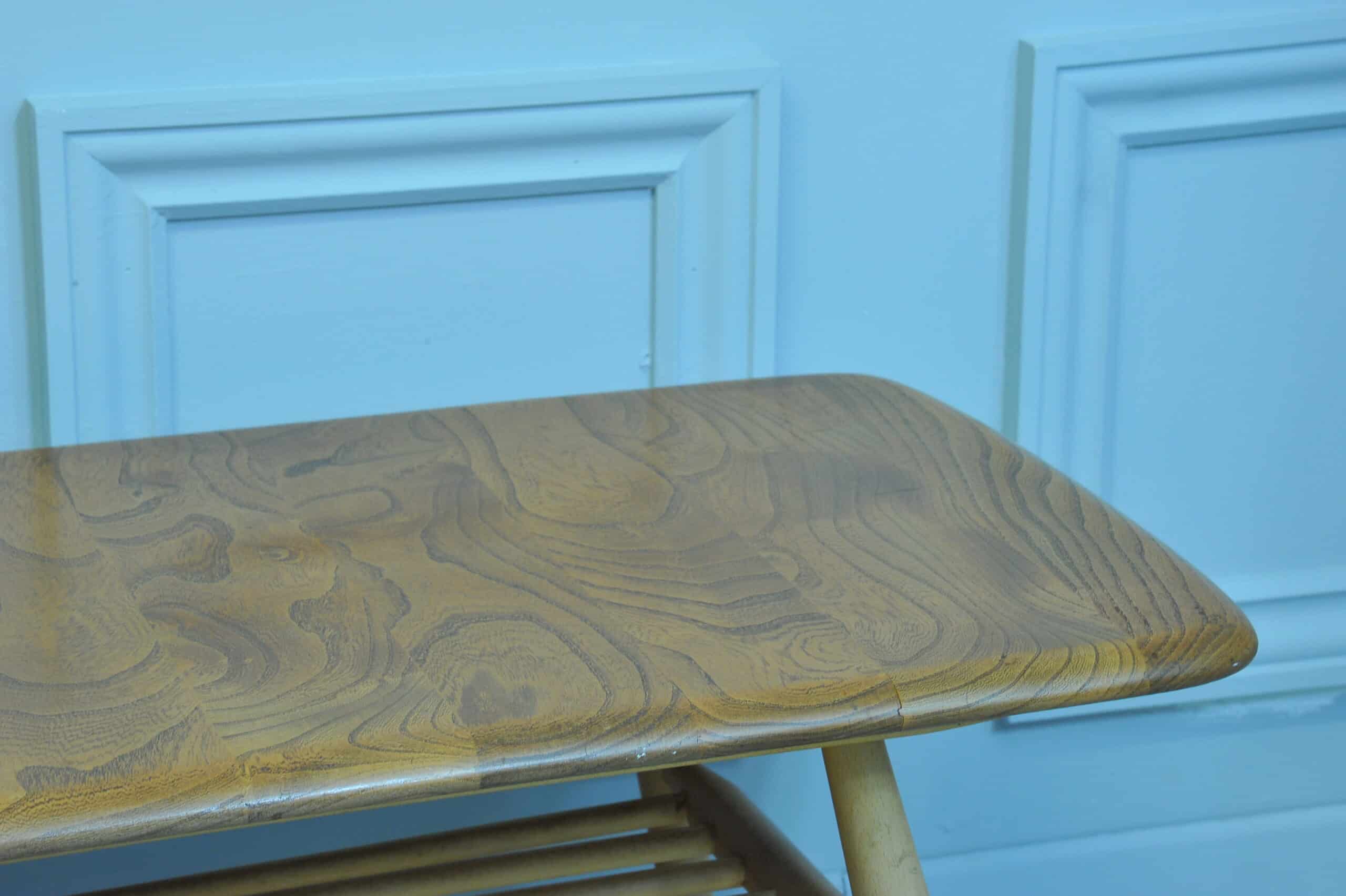 a vintage ercol long coffee table with under shelf