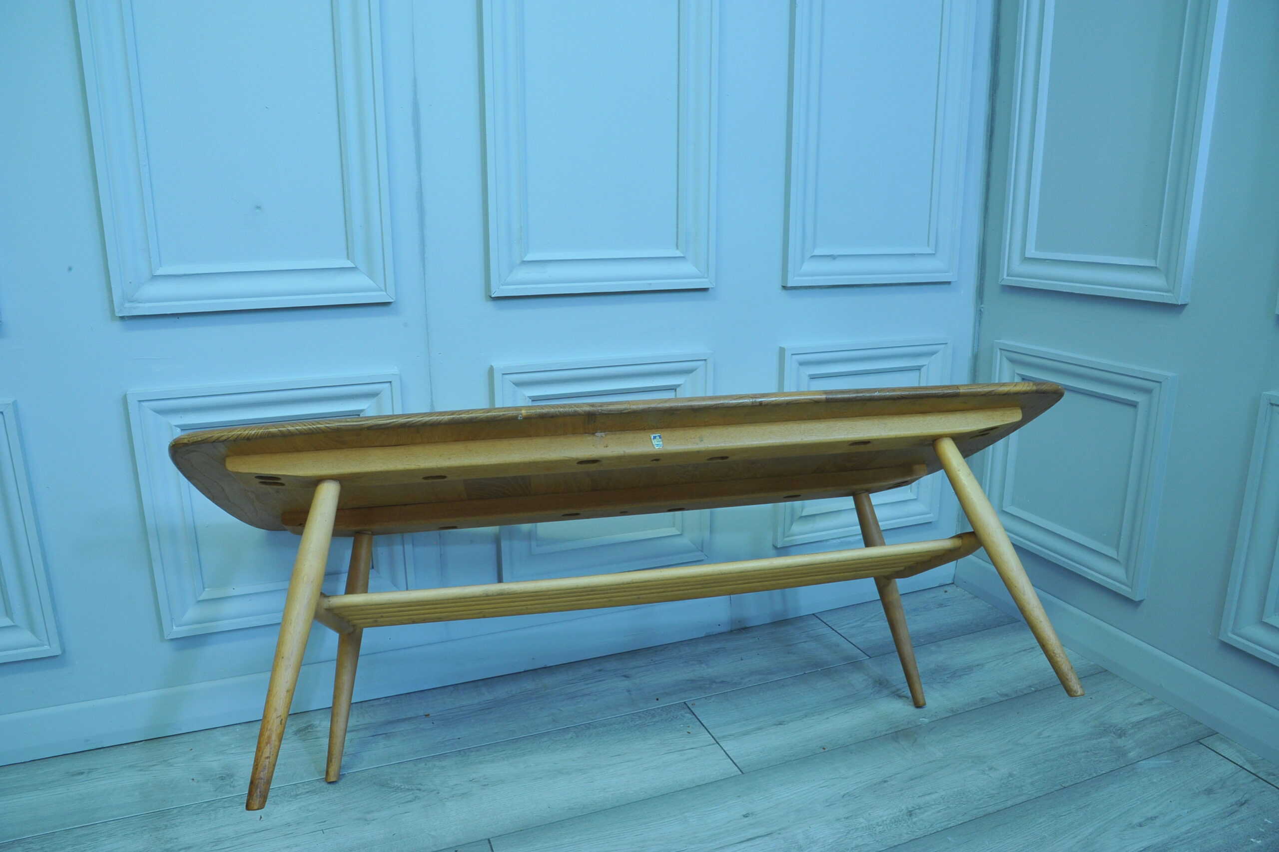 a vintage ercol long coffee table with under shelf