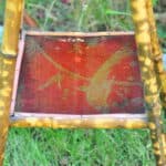 a good antique vintage two tier bamboo and lacquered panel side table