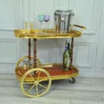 a vintage two tier brass and inlaid wood bar cart drinks trolley