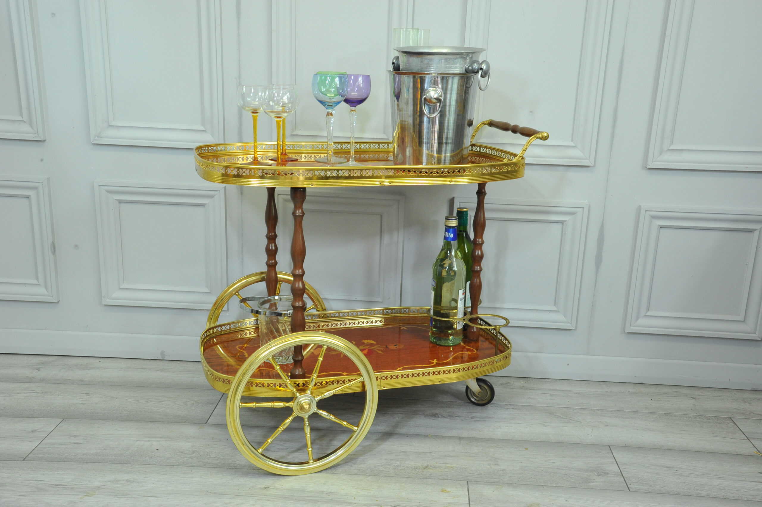 a vintage two tier brass and inlaid wood bar cart drinks trolley