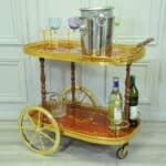 a vintage two tier brass and inlaid wood bar cart drinks trolley