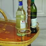 a vintage two tier brass and inlaid wood bar cart drinks trolley