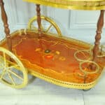 a vintage two tier brass and inlaid wood bar cart drinks trolley