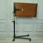 a good antique vintage cast iron and mahogany adjustable bed or side table