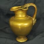 an antique brass greek trefoil oinochoe wine