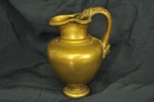 an antique brass greek trefoil oinochoe wine