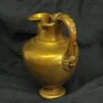 an antique brass greek trefoil oinochoe wine