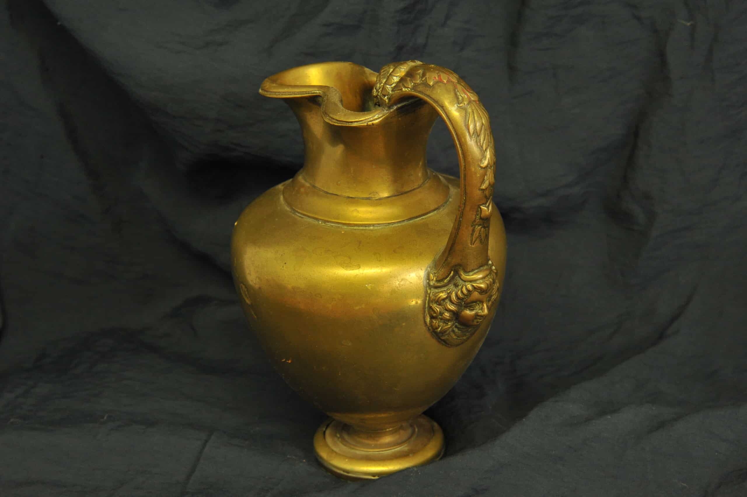 an antique brass greek trefoil oinochoe wine