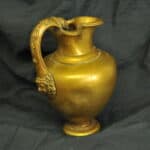 an antique brass greek trefoil oinochoe wine