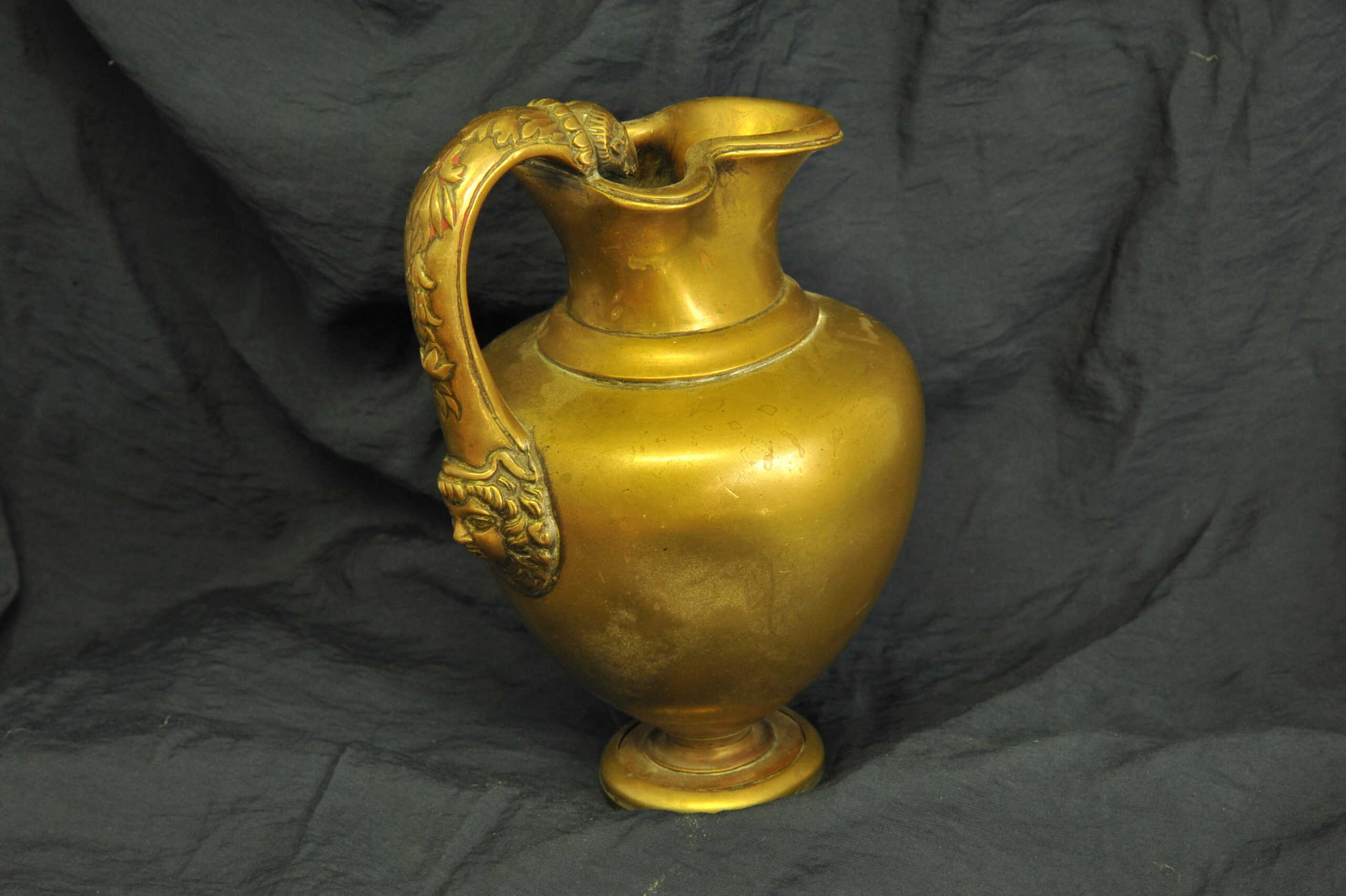 an antique brass greek trefoil oinochoe wine