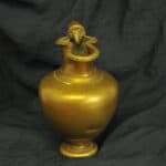 an antique brass greek trefoil oinochoe wine