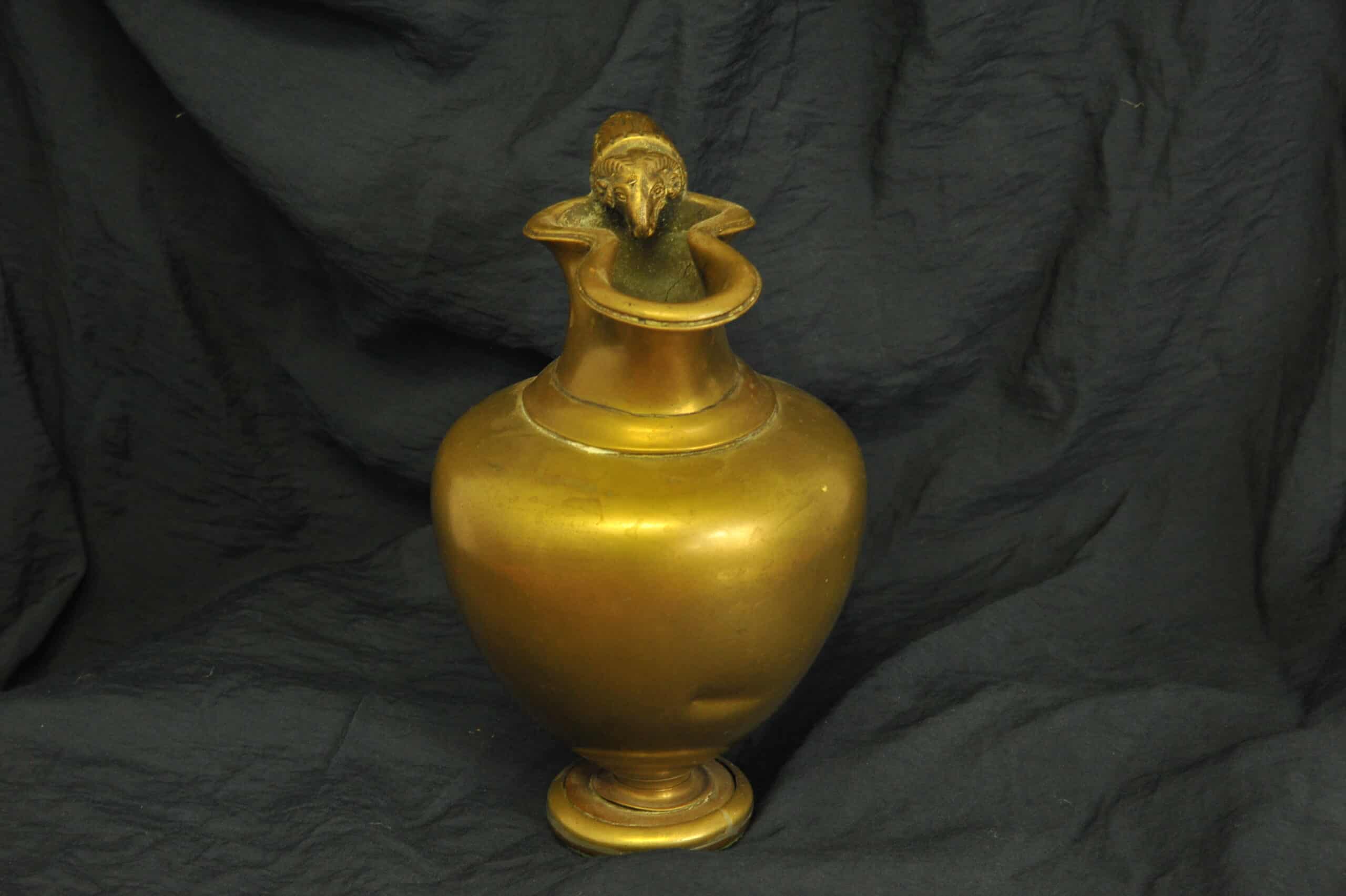 an antique brass greek trefoil oinochoe wine