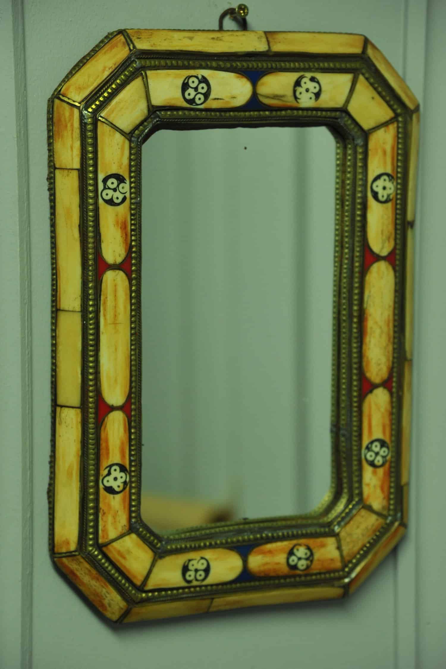 a vintage moroccan bone and brass decorated wall mirror