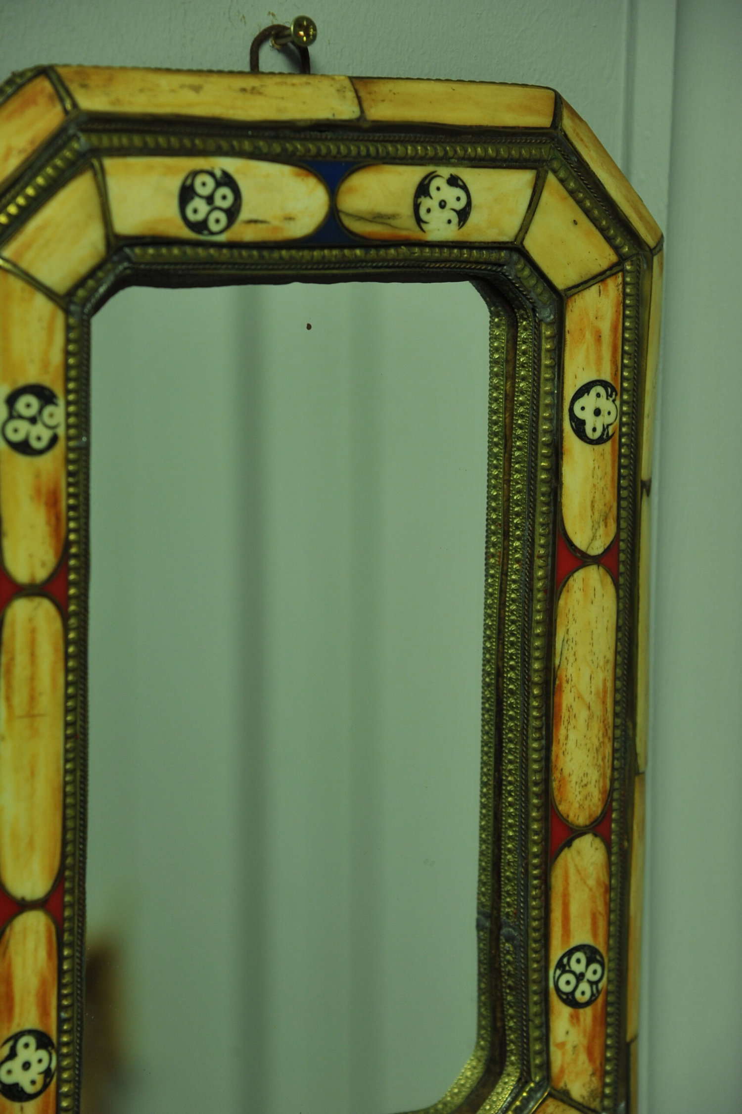 a vintage moroccan bone and brass decorated wall mirror