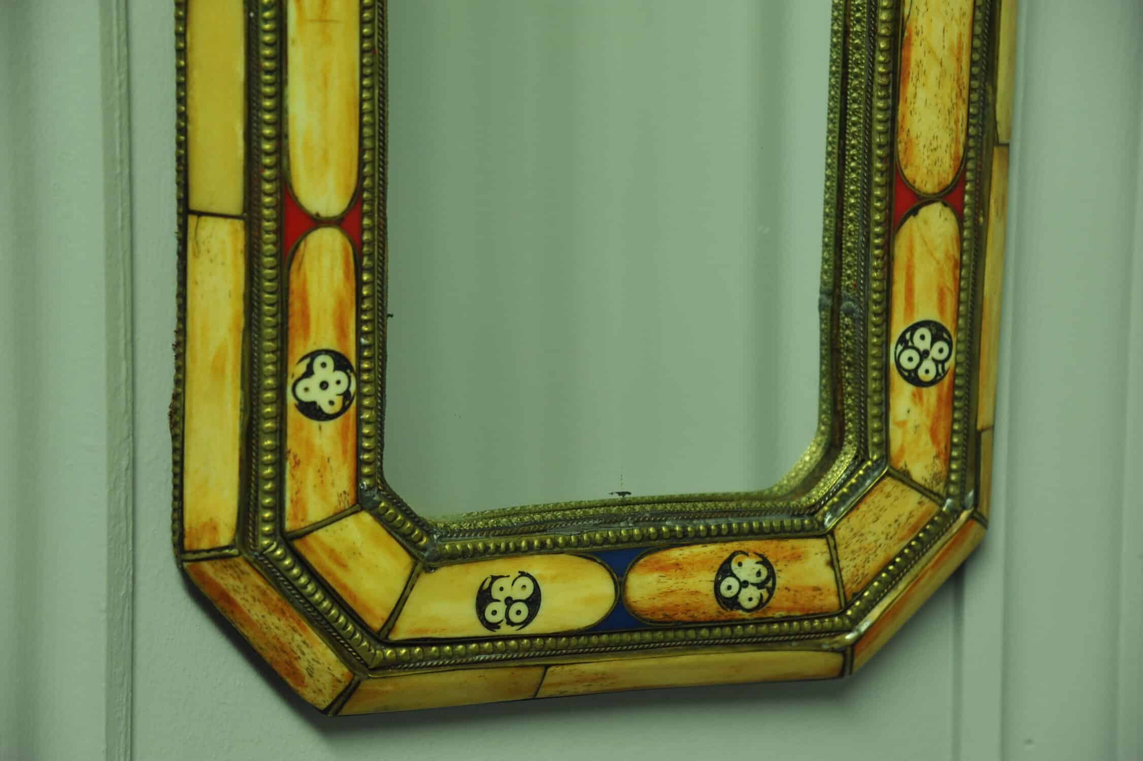 a vintage moroccan bone and brass decorated wall mirror