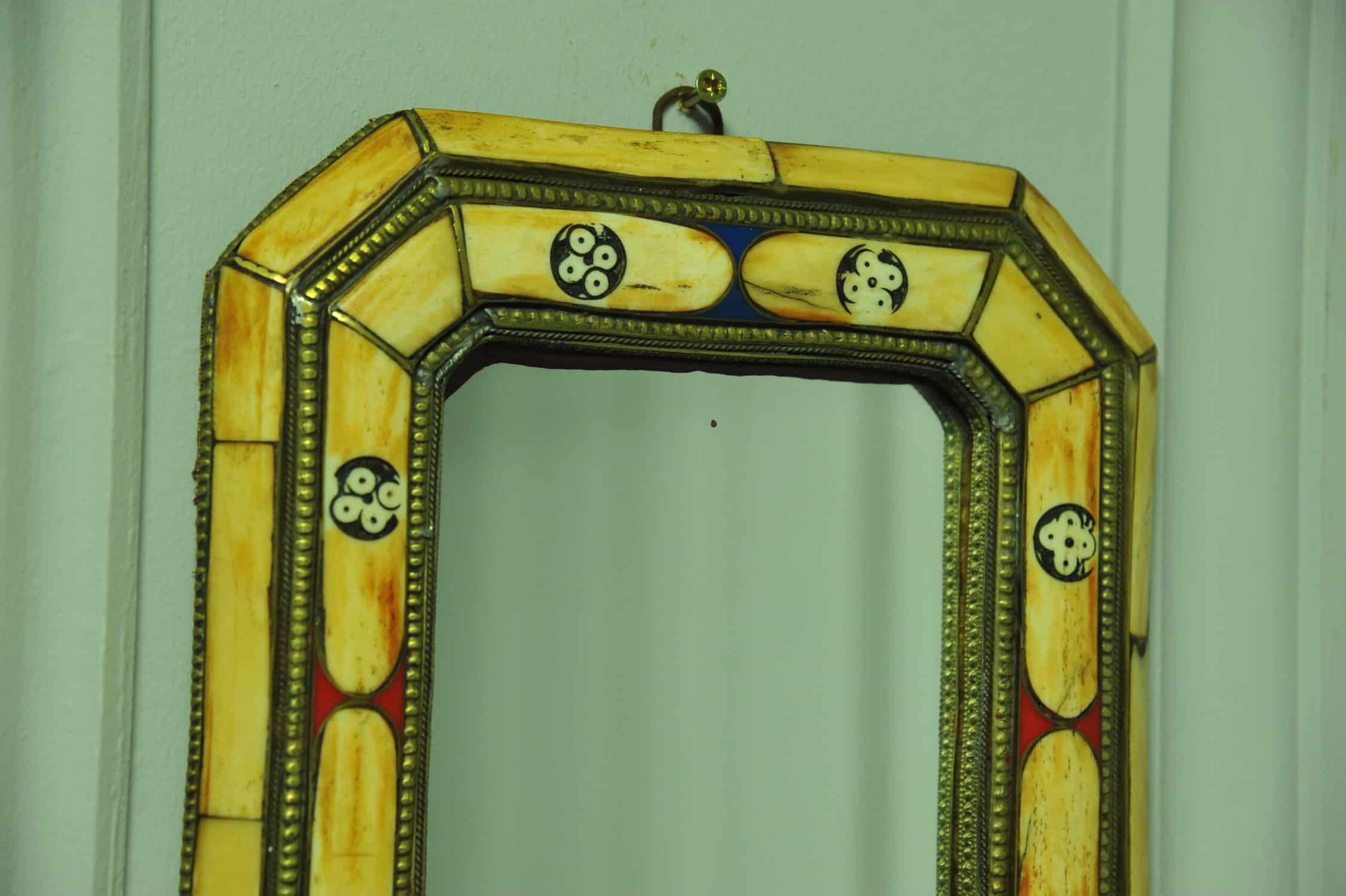 a vintage moroccan bone and brass decorated wall mirror