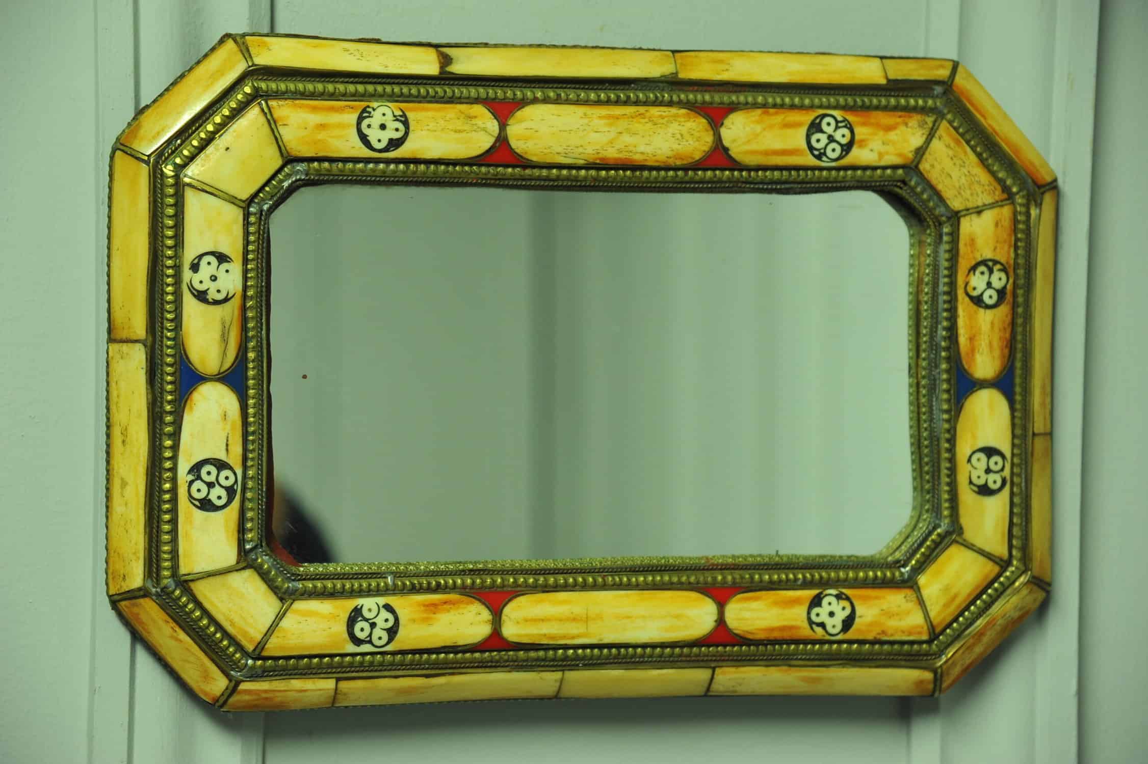 a vintage moroccan bone and brass decorated wall mirror