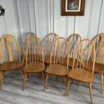 set of eight vintage ercol quaker dining chairs including two swan back carvers