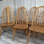 set of eight vintage ercol quaker dining chairs including two swan back carvers