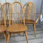 set of eight vintage ercol quaker dining chairs including two swan back carvers
