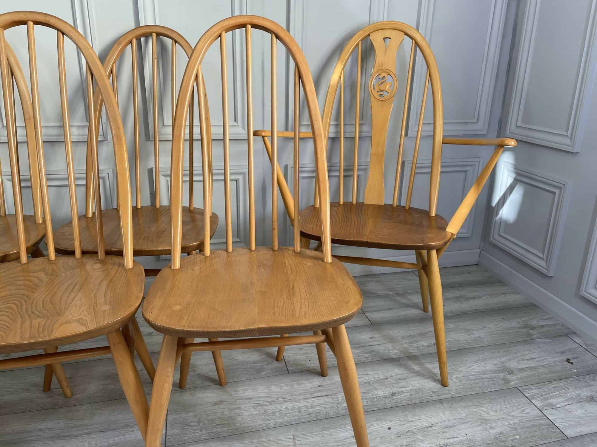 set of eight vintage ercol quaker dining chairs including two swan back carvers